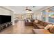 Expansive living room featuring large sectional sofa, tile flooring, and ample natural light at 10133 Longoria St, Las Vegas, NV 89178