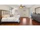 Bright, spacious main bedroom features hardwood floors, ceiling fan, and dresser at 10133 Longoria St, Las Vegas, NV 89178
