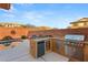 Outdoor kitchen features built-in grill and counter space by the pool at 10133 Longoria St, Las Vegas, NV 89178