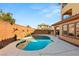 Backyard pool area features a brick wall with vibrant desert-themed decorations at 10133 Longoria St, Las Vegas, NV 89178