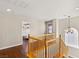 This is a staircase with wood railings, wood floors and a decorative light fixture at 10133 Longoria St, Las Vegas, NV 89178