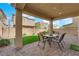 Charming covered patio with a dining set overlooking the well maintained backyard at 10792 Crestview Pointe Ave, Las Vegas, NV 89166