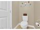 Bright bathroom features a toilet, shelf, and neutral beige paint at 10792 Crestview Pointe Ave, Las Vegas, NV 89166