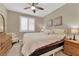 Cozy bedroom features a ceiling fan, a bed, and a wooden dresser at 10792 Crestview Pointe Ave, Las Vegas, NV 89166
