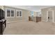 Spacious bonus room with windows and staircase features plush carpeting at 10792 Crestview Pointe Ave, Las Vegas, NV 89166