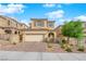Warm colored two-story house showcasing a two-car garage, brick driveway, tiled roof, and landscaped front yard at 10792 Crestview Pointe Ave, Las Vegas, NV 89166