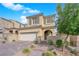 Inviting two-story home with a well-manicured lawn, brick-paved driveway, attached garage, and a gated front entry at 10792 Crestview Pointe Ave, Las Vegas, NV 89166