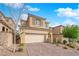 Attractive two-story house with a 2-car garage, decorative stone, and tiled roof, set against a bright blue sky at 10792 Crestview Pointe Ave, Las Vegas, NV 89166