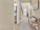 Inviting hallway featuring tile floors, wooden bench, and neutral beige paint at 10792 Crestview Pointe Ave, Las Vegas, NV 89166