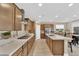Modern kitchen with an elongated island, stainless steel appliances, designer backsplash, and ample cabinet space at 10792 Crestview Pointe Ave, Las Vegas, NV 89166