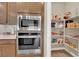 Well-equipped kitchen showcasing built-in oven/microwave, and a walk-in pantry with custom shelving at 10792 Crestview Pointe Ave, Las Vegas, NV 89166