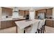 Spacious kitchen featuring a central island with seating, stainless steel appliances, and plenty of storage space at 10792 Crestview Pointe Ave, Las Vegas, NV 89166