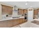 Well-lit kitchen boasts stainless steel appliances, white countertops, stylish backsplash, and custom cabinetry at 10792 Crestview Pointe Ave, Las Vegas, NV 89166