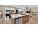 Bright kitchen with a big island with a breakfast bar that opens up to the dining area at 10792 Crestview Pointe Ave, Las Vegas, NV 89166