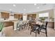 Modern kitchen with an island and dining table and lots of counter space at 10792 Crestview Pointe Ave, Las Vegas, NV 89166