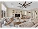 Living room with big sectional sofa and media center with a fireplace at 10792 Crestview Pointe Ave, Las Vegas, NV 89166