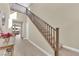 Sunlit staircase with wooden railings leads to the second floor with neutral walls at 10792 Crestview Pointe Ave, Las Vegas, NV 89166