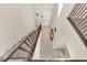 Carpeted staircase with wooden railings, and neutral walls looking down at 10792 Crestview Pointe Ave, Las Vegas, NV 89166