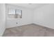 Neutral carpeted bedroom with a large window and ample natural light at 12367 Indigo Montage Rd # 3, Las Vegas, NV 89183