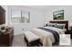 Comfortable bedroom with a queen-sized bed, dresser, and a window overlooking the outdoors at 12367 Indigo Montage Rd # 3, Las Vegas, NV 89183