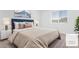 Bright bedroom featuring a plush bed, stylish bedside table, and a large window for natural light at 12367 Indigo Montage Rd # 3, Las Vegas, NV 89183