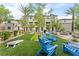 Community green space with Adirondack chairs, picnic tables and outdoor games at 12367 Indigo Montage Rd # 3, Las Vegas, NV 89183