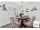Bright dining area with a round wooden table, comfortable seating, and natural light from the window at 12367 Indigo Montage Rd # 3, Las Vegas, NV 89183