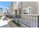 Modern home exterior with black metal fence and landscaped yard at 12367 Indigo Montage Rd # 3, Las Vegas, NV 89183