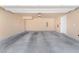 Spacious, empty two car garage featuring sealed concrete floors at 12367 Indigo Montage Rd # 3, Las Vegas, NV 89183