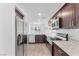 Beautiful kitchen featuring stainless steel appliances, granite countertops, and dark wood cabinetry at 12367 Indigo Montage Rd # 3, Las Vegas, NV 89183