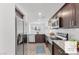 Modern kitchen featuring stainless steel appliances, granite countertops, and dark wood cabinetry at 12367 Indigo Montage Rd # 3, Las Vegas, NV 89183