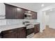 Close-up on kitchen with stainless steel appliances, dark cabinets, and granite countertop at 12367 Indigo Montage Rd # 3, Las Vegas, NV 89183