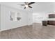Bright, open-concept living room with modern flooring and a ceiling fan at 12367 Indigo Montage Rd # 3, Las Vegas, NV 89183