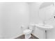 Clean powder room featuring a pedestal sink and modern fixtures at 12367 Indigo Montage Rd # 3, Las Vegas, NV 89183
