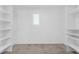 A walk-in closet with installed shelving and a window at 12367 Indigo Montage Rd # 3, Las Vegas, NV 89183
