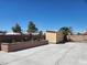 Backyard with a tan shed surrounded by planters and palms at 1255 Del Lilly Ln, Las Vegas, NV 89123