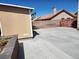 Backyard tan storage shed with driveway and red tile roof house at 1255 Del Lilly Ln, Las Vegas, NV 89123