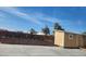 A large shed sits next to a block wall with plants in the backyard at 1255 Del Lilly Ln, Las Vegas, NV 89123