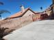 Home's driveway with terracotta tile roof and security gate at 1255 Del Lilly Ln, Las Vegas, NV 89123