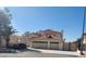 Two-story home featuring a red tile roof, a three-car garage, and lush landscaping in a well-maintained front yard at 1255 Del Lilly Ln, Las Vegas, NV 89123