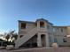 Apartment complex exterior featuring stucco construction, open stairways, and well-maintained landscaping at 1881 W Alexander Rd # 2095, North Las Vegas, NV 89032