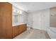 Bathroom with wood cabinets, dual sinks, and a soaking tub at 200 W Sahara Ave # 3004, Las Vegas, NV 89102