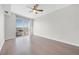 Spacious bedroom with hardwood floors, ceiling fan, and city views from a large window at 200 W Sahara Ave # 3004, Las Vegas, NV 89102