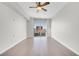 Spacious bedroom with hardwood floors, ceiling fan, and city views from a large window at 200 W Sahara Ave # 3004, Las Vegas, NV 89102