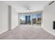 Modern living room featuring sleek tile floors, a ceiling fan, and a wall of windows offering scenic city views at 200 W Sahara Ave # 3004, Las Vegas, NV 89102