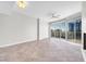Bright living room featuring scenic city views from the oversized windows with balcony access and a ceiling fan at 200 W Sahara Ave # 3004, Las Vegas, NV 89102