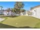 Spacious backyard featuring an artificial turf putting green and shaded seating area at 2101 Diamond Bar Dr, Las Vegas, NV 89117