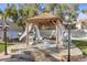 Backyard gazebo with comfortable seating, elegant lighting, and privacy curtains at 2101 Diamond Bar Dr, Las Vegas, NV 89117