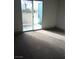 Bright bedroom features a sliding glass door to a patio and neutral carpet at 2109 Echo Bay St # 104, Las Vegas, NV 89128