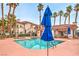 Inviting community pool surrounded by lounge chairs and palm trees for relaxation at 2109 Echo Bay St # 104, Las Vegas, NV 89128